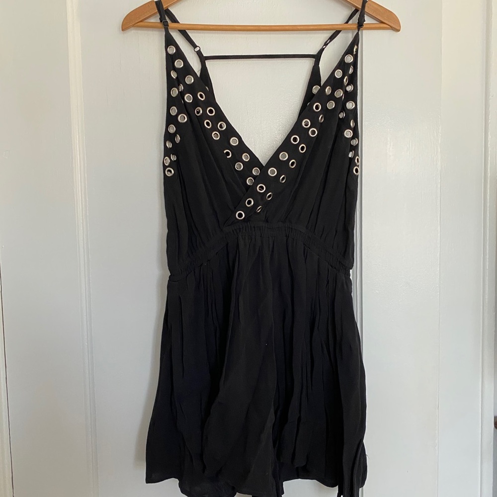 NWT black romper with silver hole details